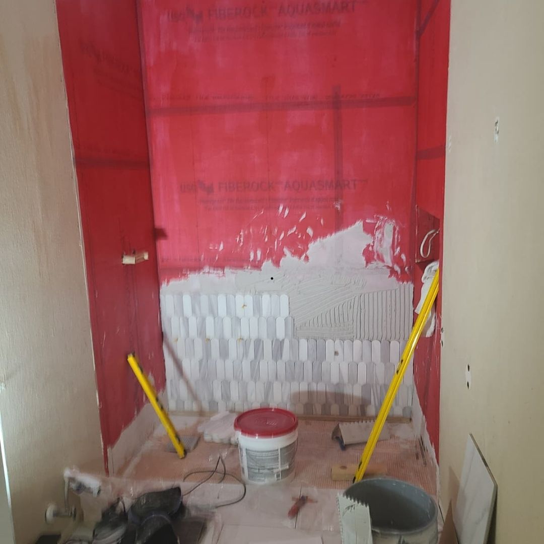 In-progress small bathroom remodel in Houston with waterproofing and tile installation