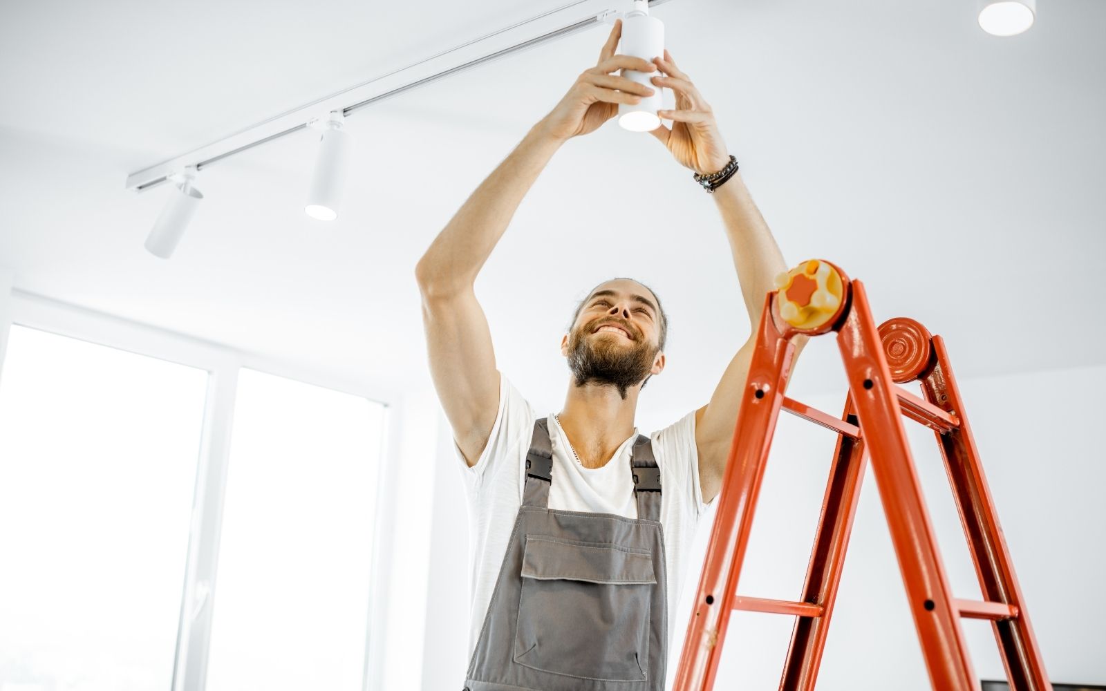 Electrician upgrading electrical panel and lighting in Houston home